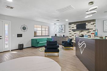 Large room with desk, couch and chairs
